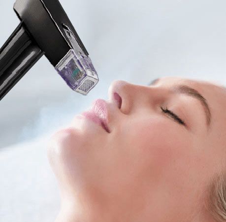 RF microneedling handpiece treating the face at Unique Aesthetics